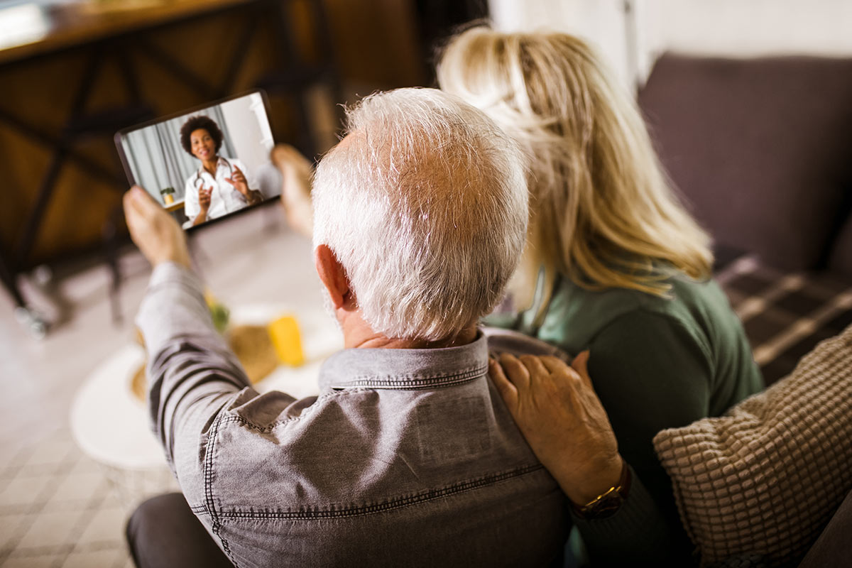 couple listening to doctor from the tablet